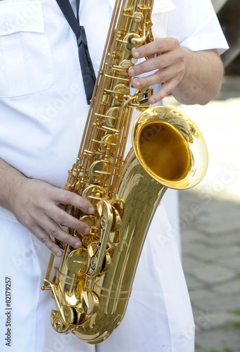 Adult male playing a tenor saxophone