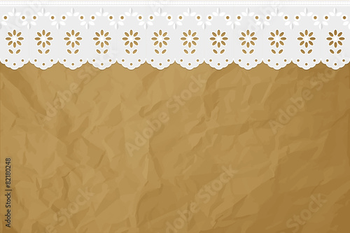 Openwork embroidery on crumpled paper brown background