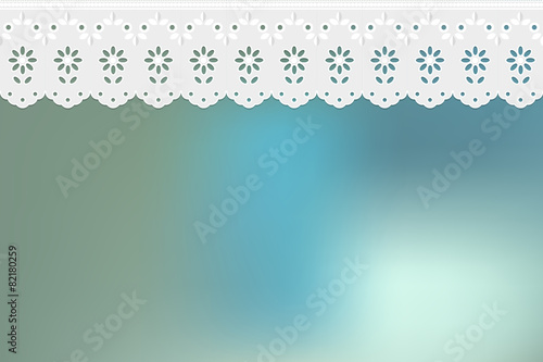 Openwork embroidery on blue bokeh background