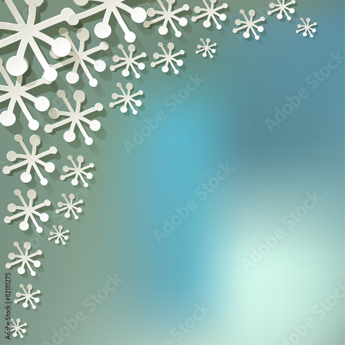 White paper snowflakes on blue bokeh background