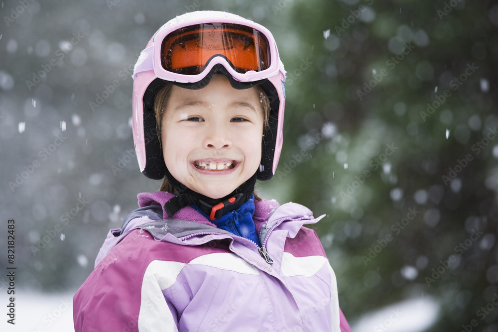 Asian girl wearing ski gear in snow Asian girl wearing ski gear in snow