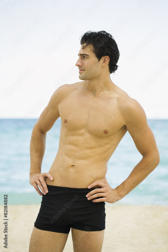 Caucasian man standing on beach Caucasian man standing on beach