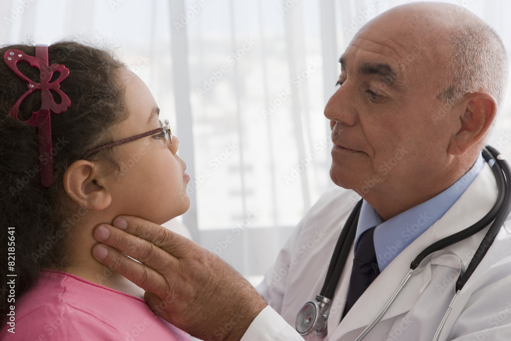 Hispanic doctor checking patient's throat Hispanic doctor checking patient's throat