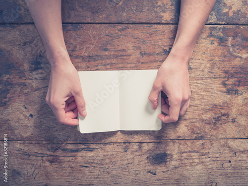 Female hands opening small notepad