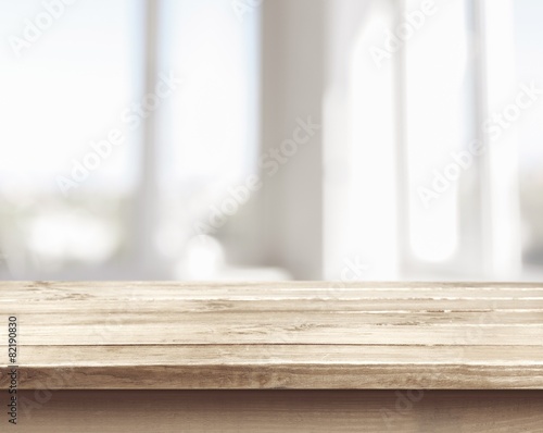 Background. Wooden table on defocuced window with curtain