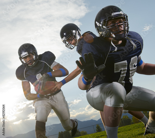 Football players passing ball