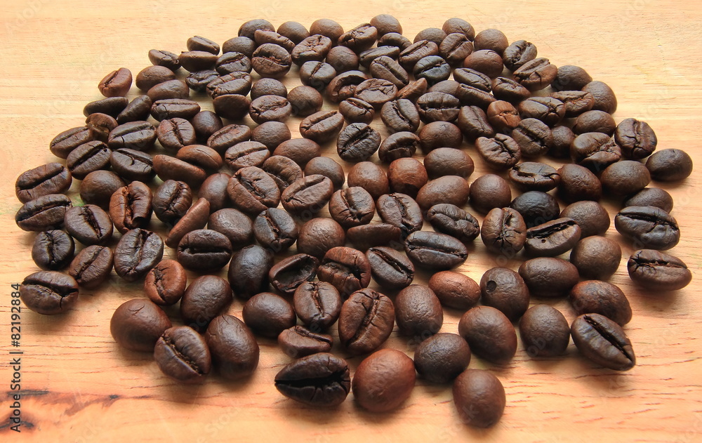 Roasted brown coffee beans,on wood background