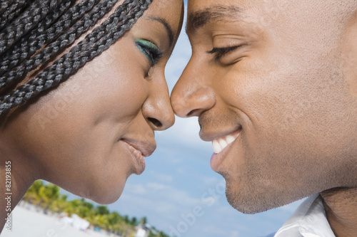 African couple smiling at each other photo
