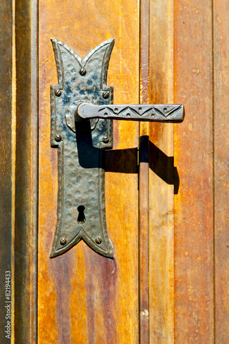 castellanza blur  brown knocker in a  door c  wood italy   cross