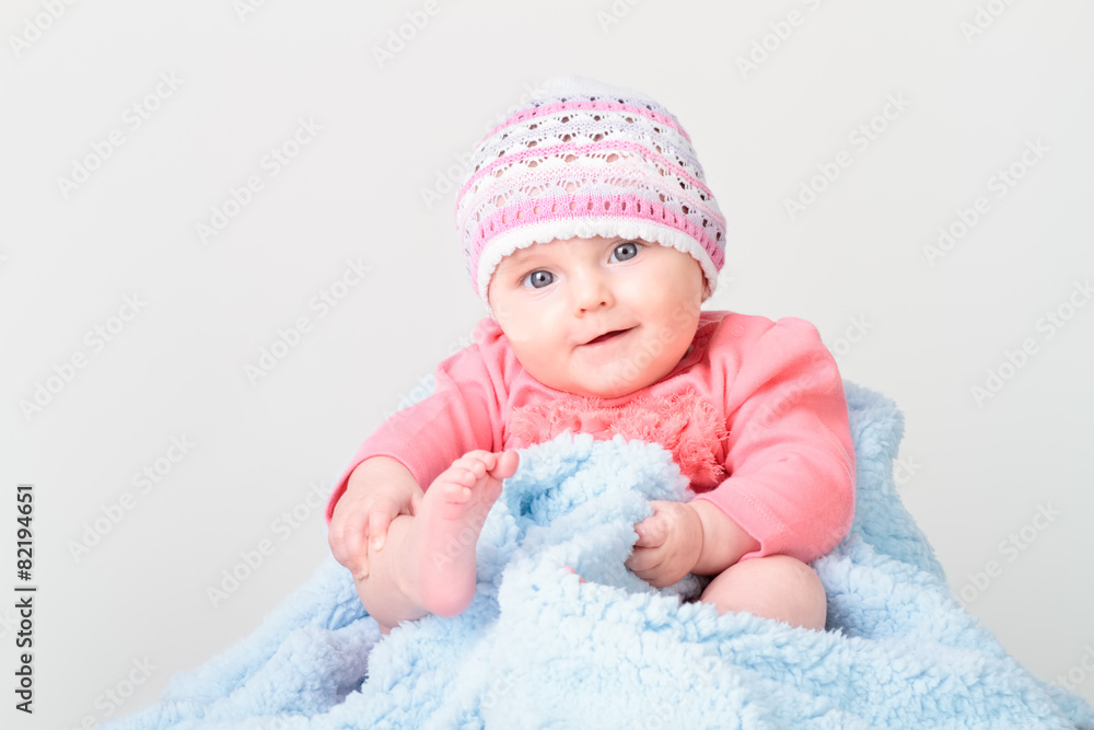 Little smiling baby girl sitting on blanket Little smiling baby girl sitting on blanket