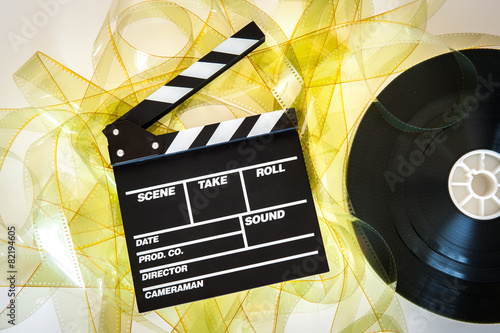 Empty yellow 35 mm film unrolled with clapper board and movie re