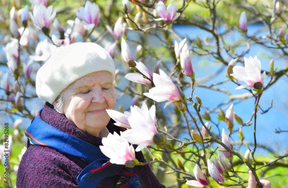 Senior woman smiling and dreaming in garden.
