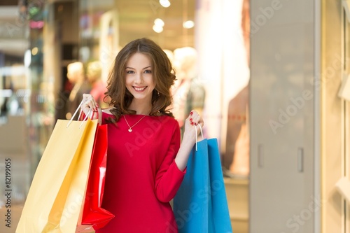 Retail. Young woman holding shopping bags