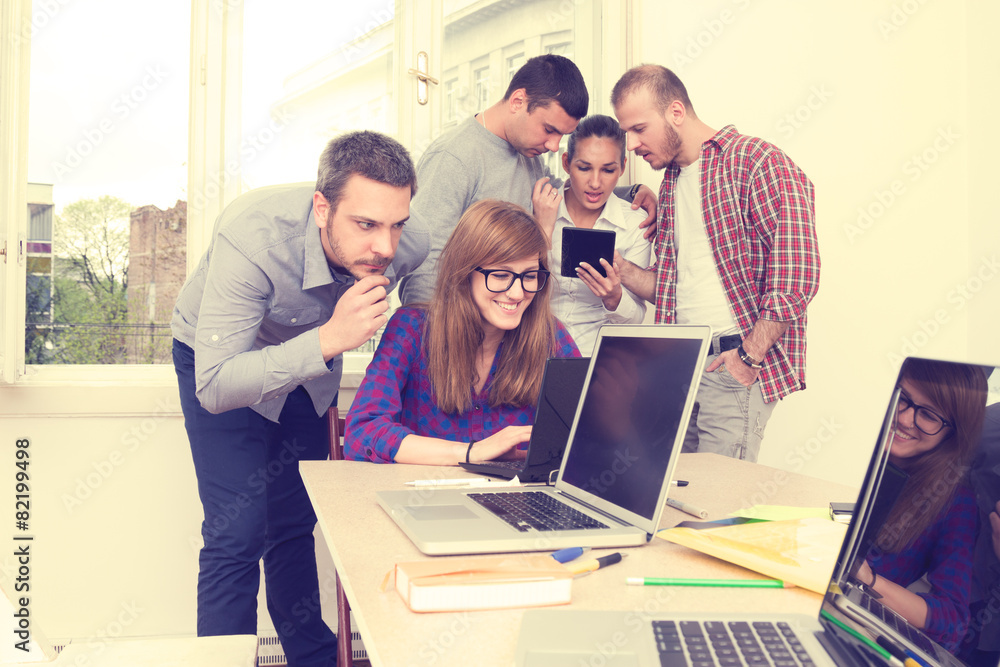 Young group of people discussing business plans. Young group of people discussing business plans.