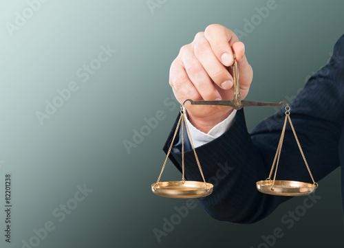 Scale. Businessman hand holding a balance on white background