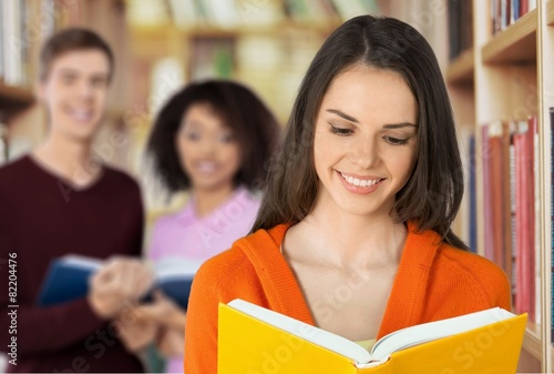 Teenage Girls. Smiling Teenage Schoolgirl With Book on School © BillionPhotos.com