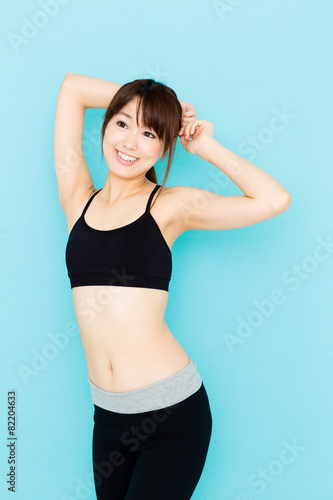 sporty asian woman on blue background