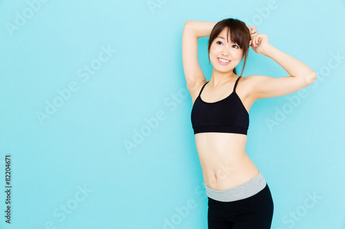 sporty asian woman on blue background