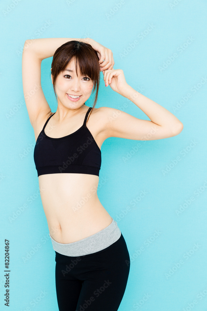 sporty asian woman on blue background sporty asian woman on blue background