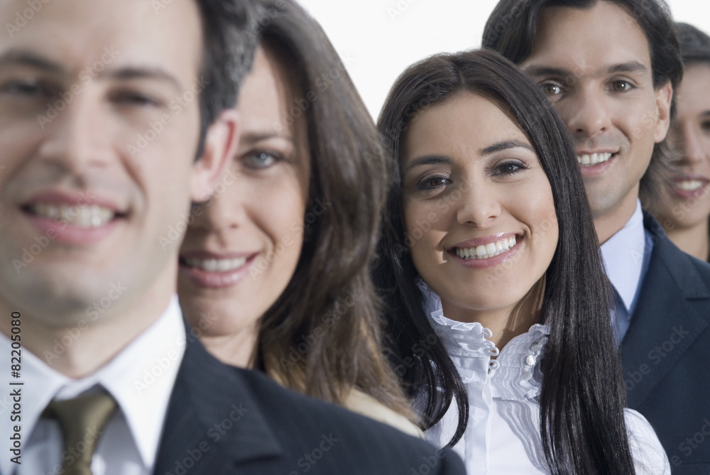 Hispanic co-workers standing in row Hispanic co-workers standing in row