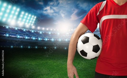 Soccer. Midsection of a soccer player holding a ball