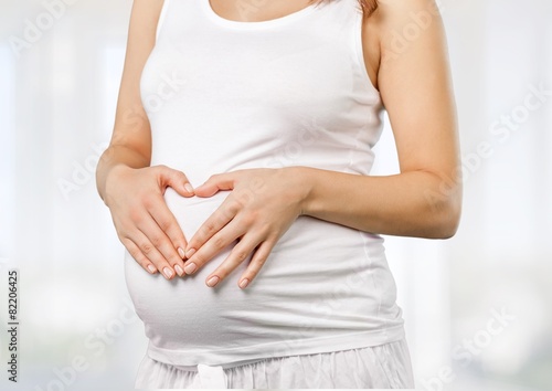 Wallpaper Mural Abdomen. Pregnant woman belly, pregnancy heart shape, love sign Torontodigital.ca