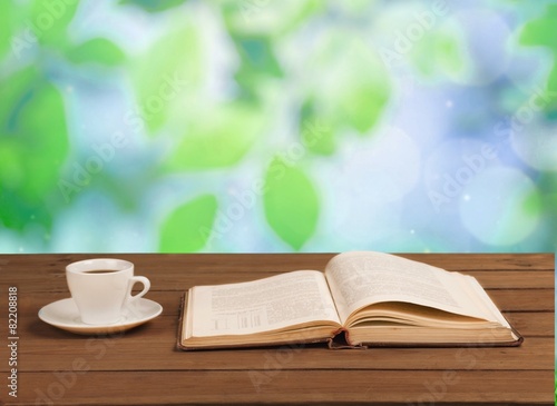 Book. Cup of coffee and a book on a wooden table