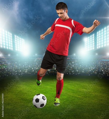 Soccer. Professional soccer player kicking ball. Isolated on