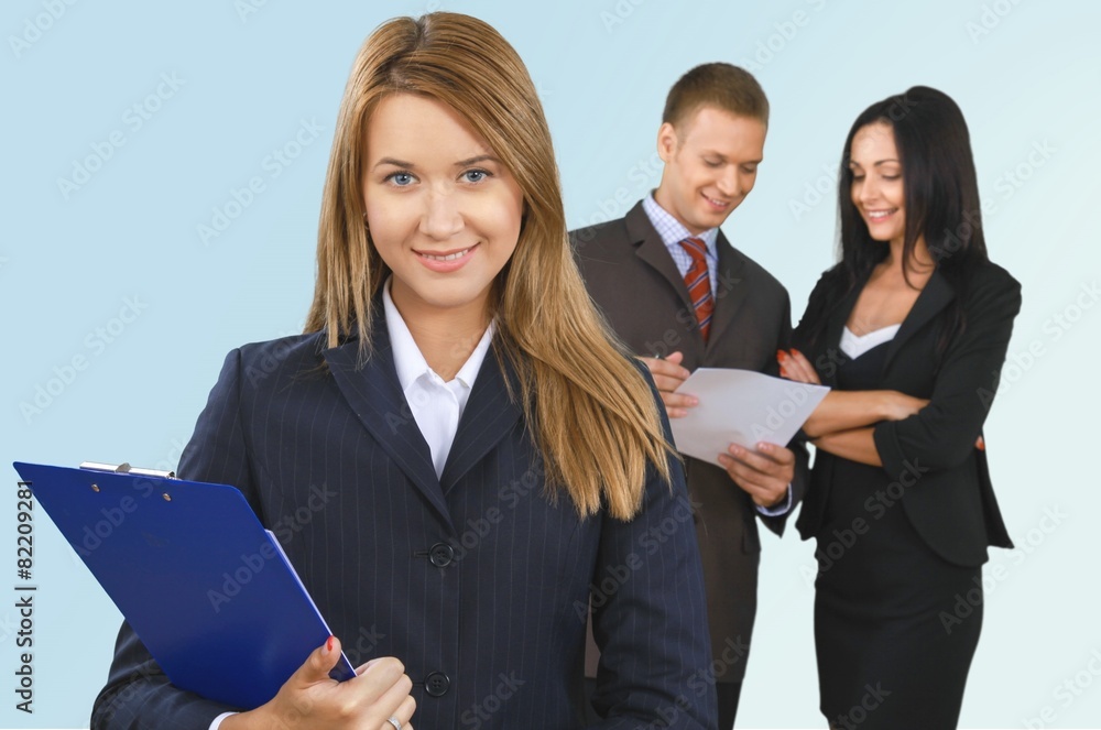 Business. Happy businesswoman with colleagues in the background Business. Happy businesswoman with colleagues in the background