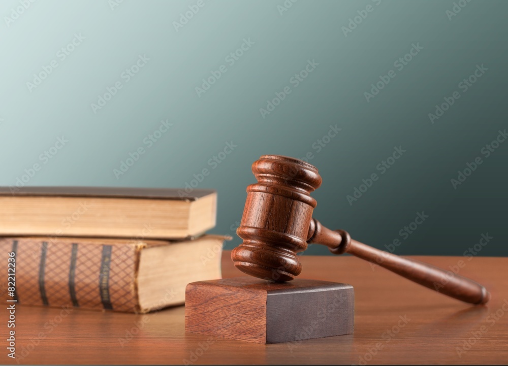 Gavel. Wooden mallet and books on a green background Gavel. Wooden mallet and books on a green background