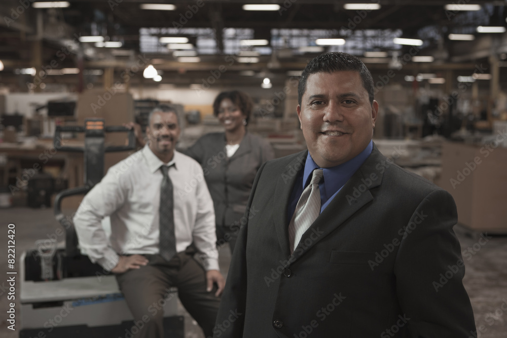 Business people standing in warehouse Business people standing in warehouse