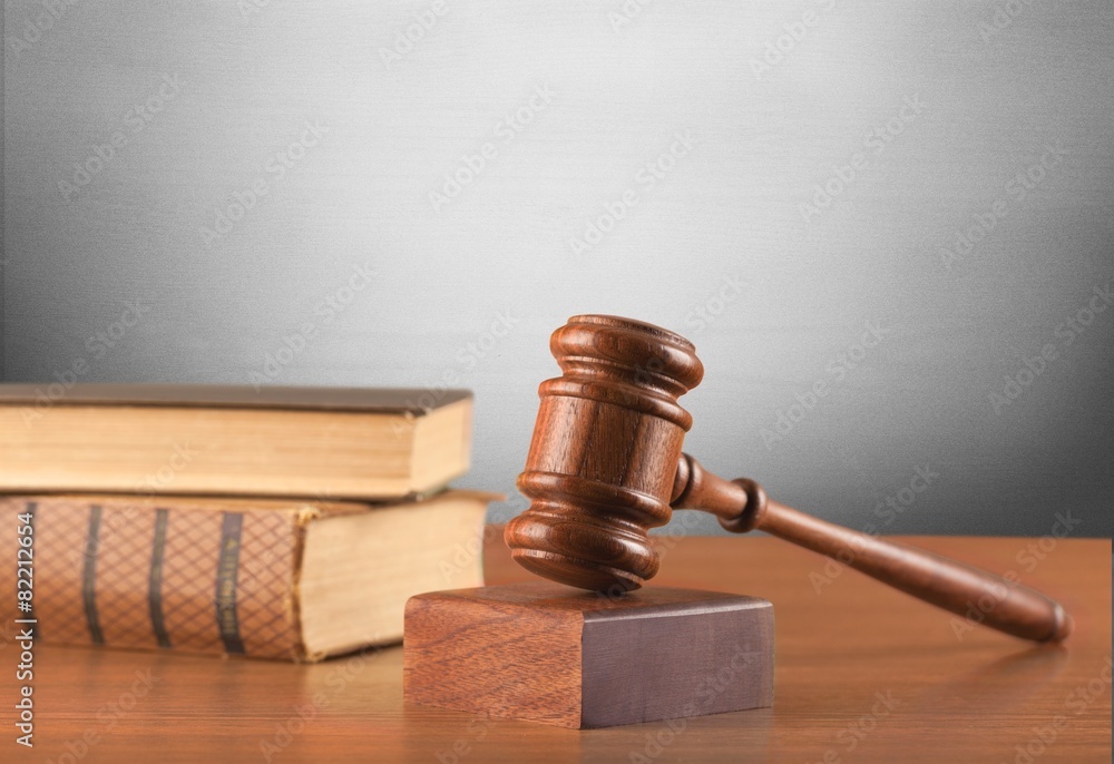 Gavel. Wooden mallet and books on a green background Gavel. Wooden mallet and books on a green background