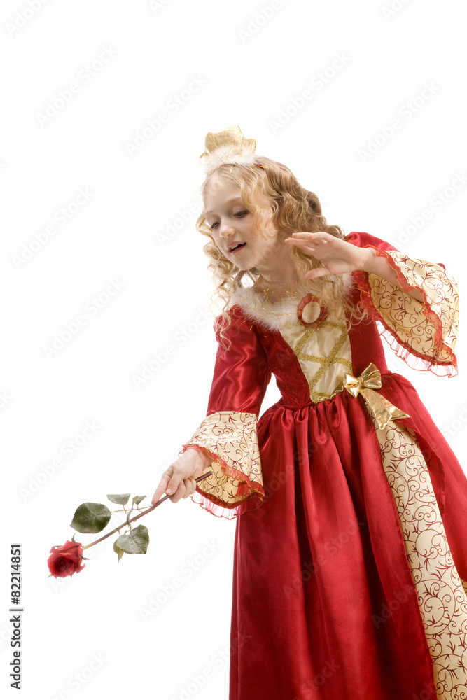 Beautiful little princess using red rose like a magic wand