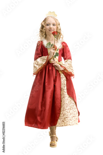 Beautiful little girl in princess costume standing with red rose