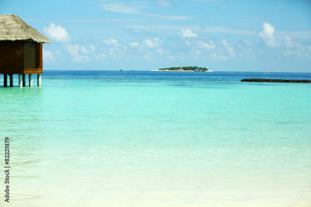View of beautiful blue ocean water and bungalows in Baros Maldives View of beautiful blue ocean water and bungalows in Baros Maldives