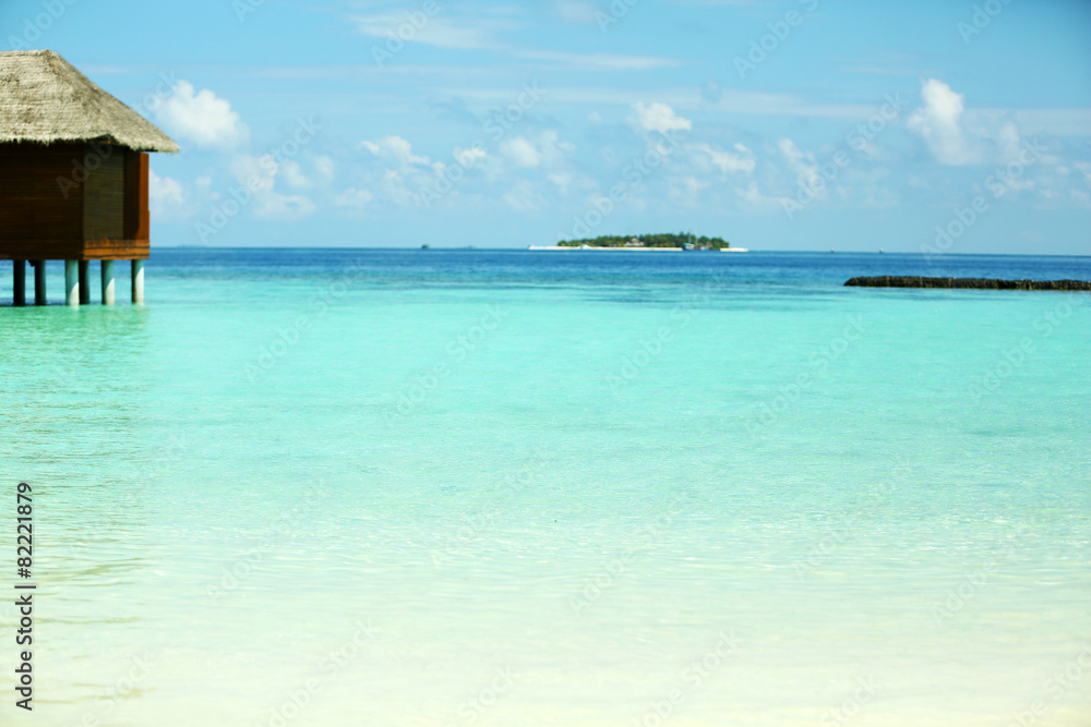 View of beautiful blue ocean water and bungalows in Baros Maldives