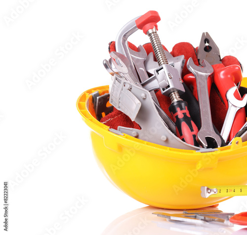 Construction tools in helmet isolated on white