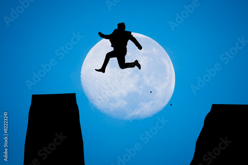 silhouette Man Jumping in sun rise with big moon