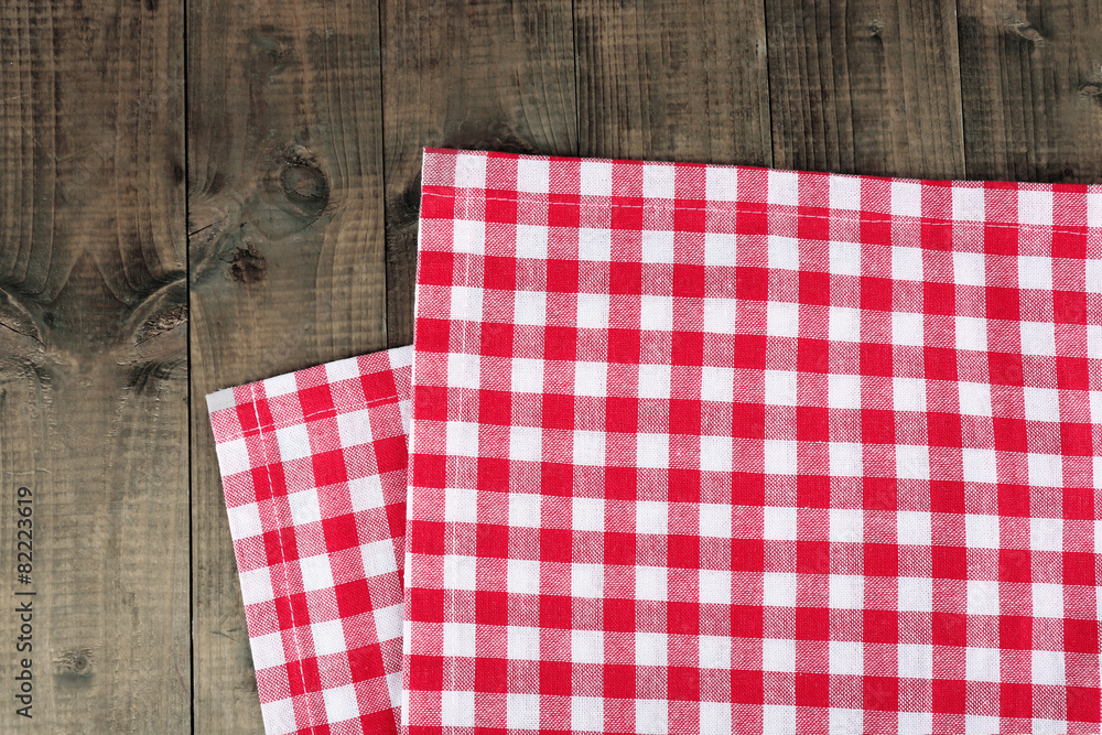 Checkered napkin on wooden table background Checkered napkin on wooden table background
