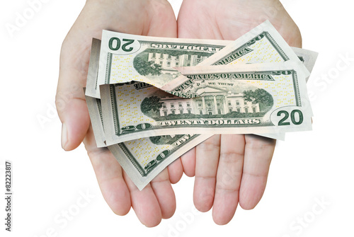 Many dollars falling on woman's hand with money, torn paper.