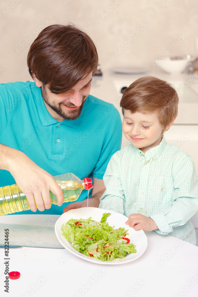Father and son make salad dressing
