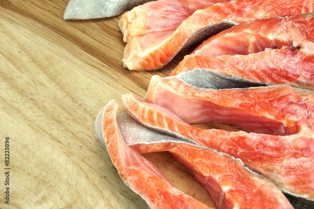 Fresh Raw Salmon Fish Steaks On Wood Cutting Board