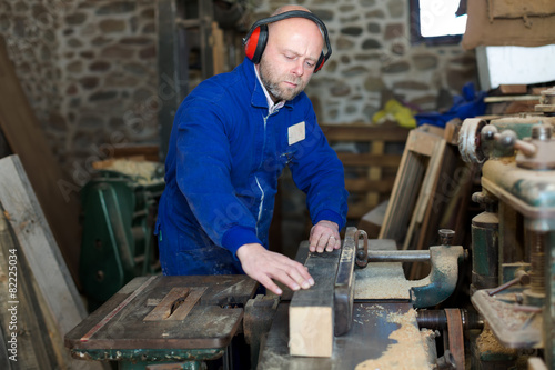 Carpenter using woodworking machine
