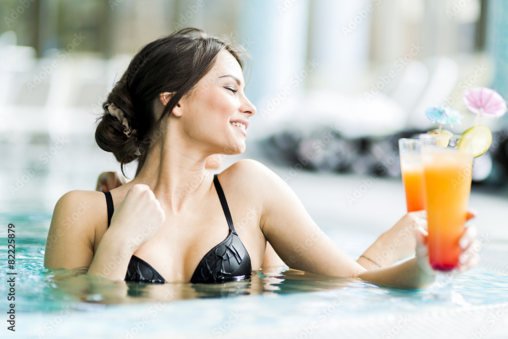 Beautiful young women drinking a cocktails in the swimming pool Beautiful young women drinking a cocktails in the swimming pool