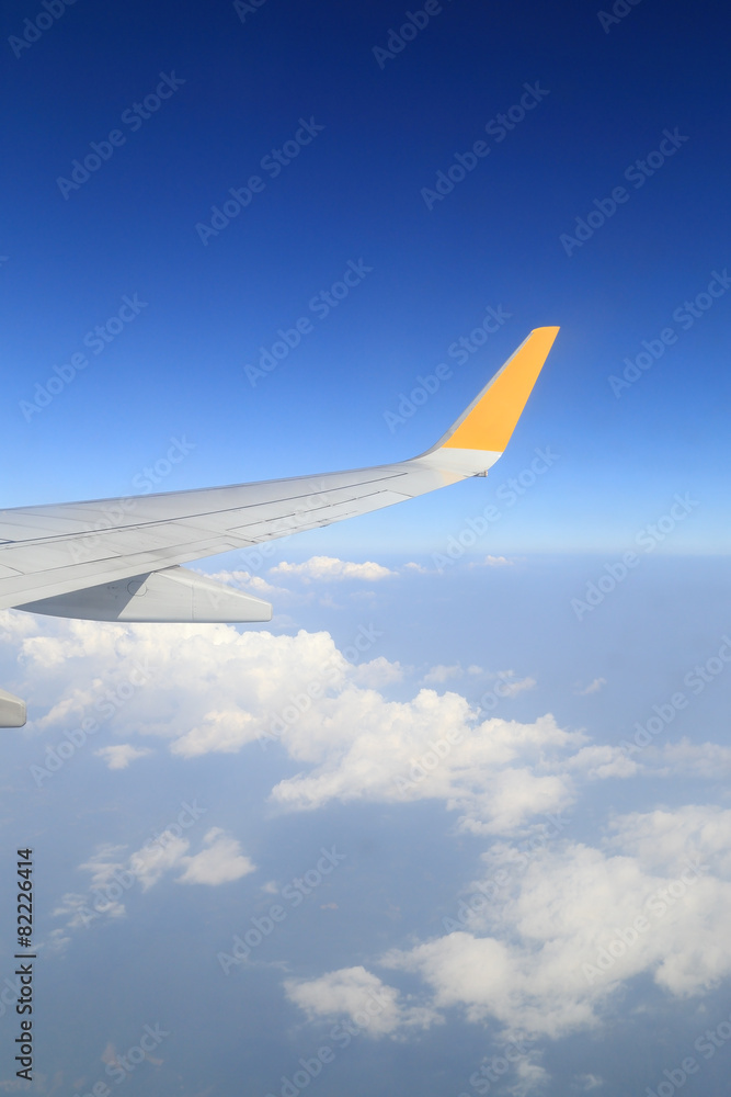 Wing of an airplane flying above sky Wing of an airplane flying above sky