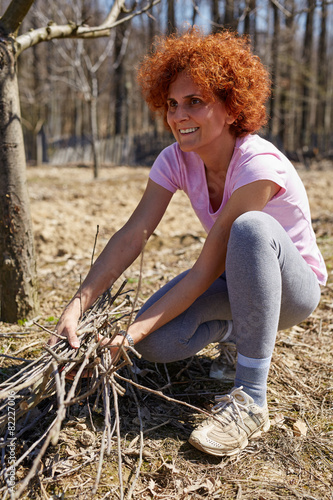 Woman spring cleaning the orchard