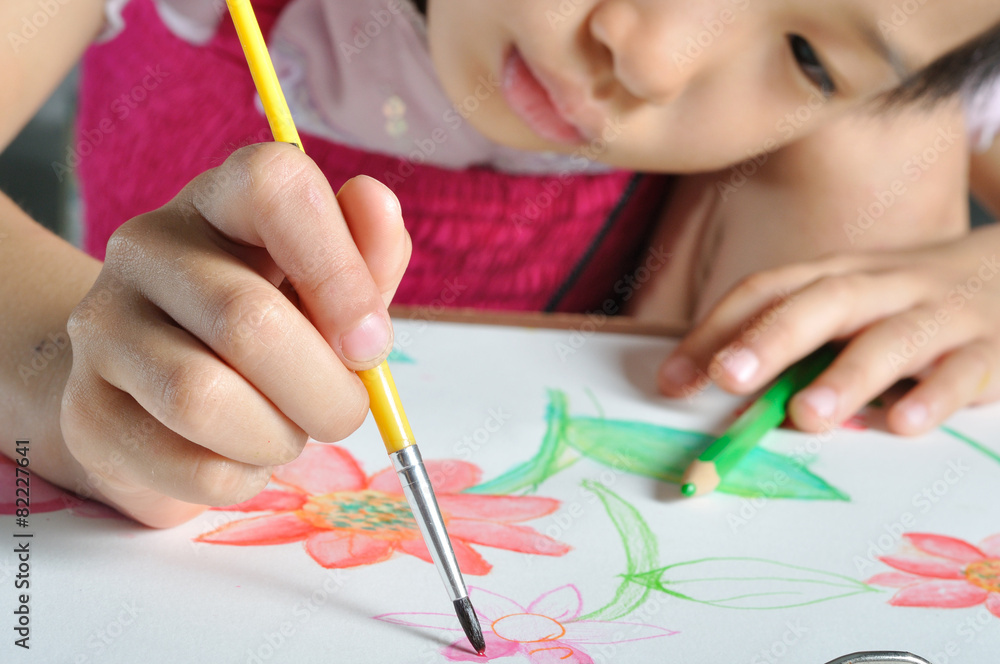closeup little Asian girl hand paint with her watercolor pictur closeup little Asian girl hand paint with her watercolor pictur