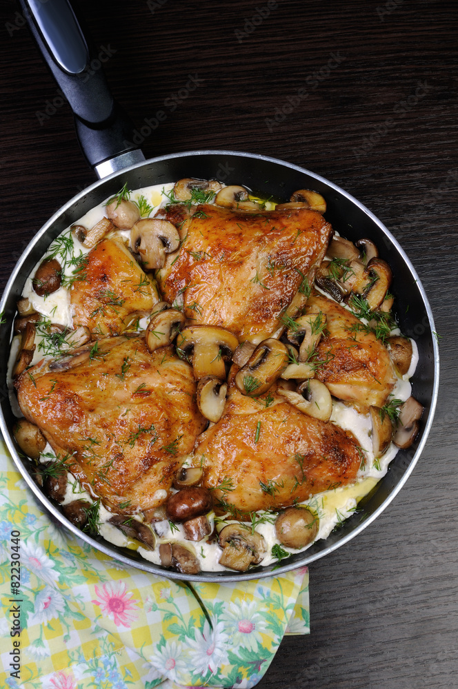 Fototapeta premium part of the chicken in a creamy sauce with mushrooms