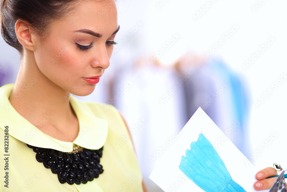 Modern young fashion designer working at studio. Modern young fashion designer working at studio.