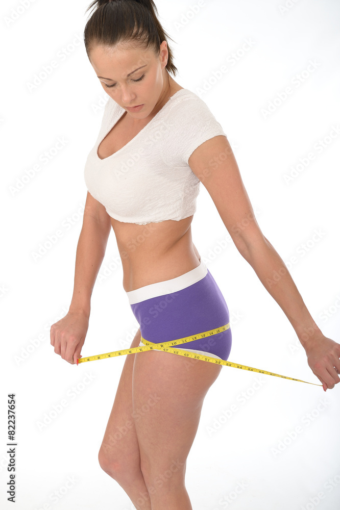 Healthy Young Woman Checking Her Weight Loss With a Tape Measure Healthy Young Woman Checking Her Weight Loss With a Tape Measure